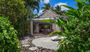 Premium Garden Villa private front yard that features a beautifully arranged-stepping-stone that leads to the villa, showcasing a lush tropical garden surroundings that gives a private and romantic vibe