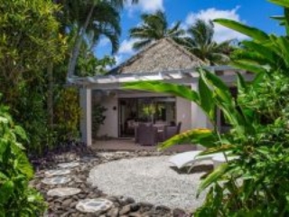 Premium Garden Villa private front yard that features a beautifully arranged-stepping-stone that leads to the villa, showcasing a lush tropical garden surroundings that gives a private and romantic vibe