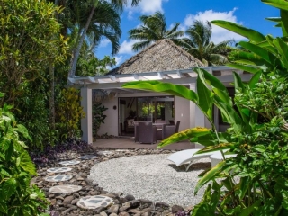 Premium Garden Villa private front yard that features a beautifully arranged-stepping-stone that leads to the villa, showcasing a lush tropical garden surroundings that gives a private and romantic vibe