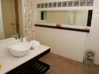 image of the Premium Garden Suite vanity showcasing an oval-shaped porcelain white deep basin mounted on a flat top with a built-in lower rack for towel storage, also featuring a dressing mirror to give a perfect touch