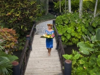 front view image of the delicious tropical fruit platter happily modelled by a resort staff walking in the midst of the breath-taking Pacific Resort lush garden