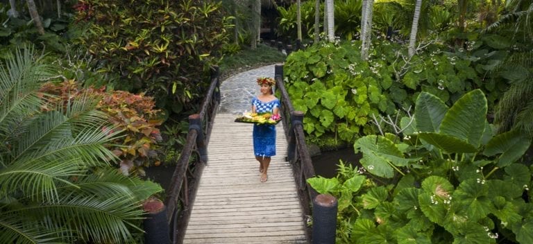 front view image of the delicious tropical fruit platter happily modelled by a resort staff walking in the midst of the breath-taking Pacific Resort lush garden