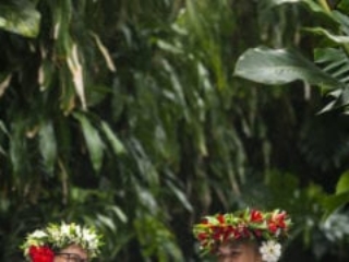 an image capturing two happy house keeping attendants proudly showcasing their housekeeping skills