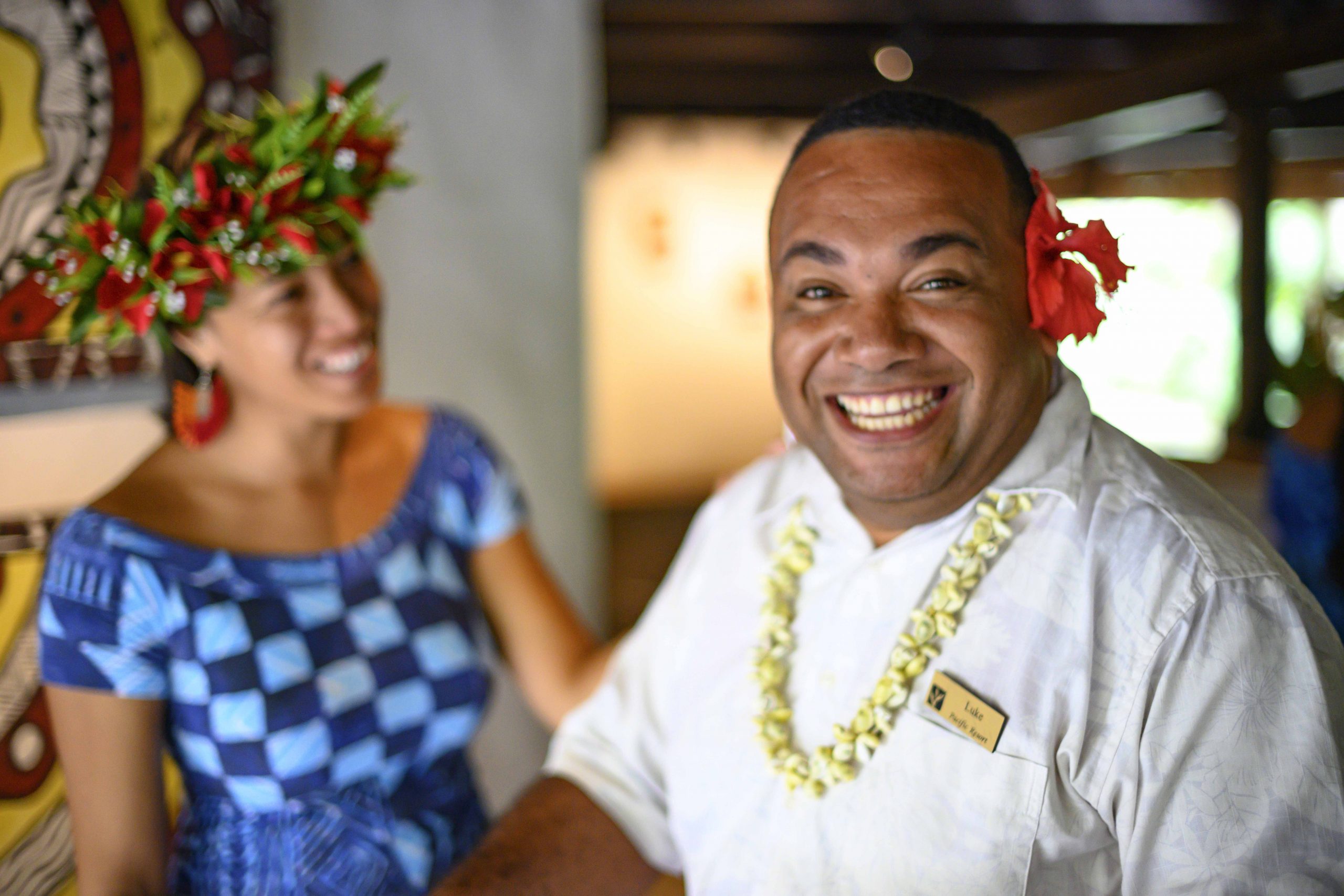 an image capturing two happy guest services agents smiling away, showcasing what Pacific Islanders are known for