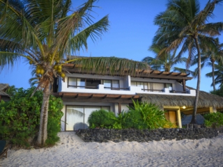 view of the Premium Beachfront Suites from the beach featuring a clear stunning blue sky in the background