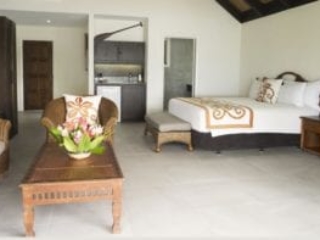 Interior image of the Premium Beachfront Suite showcasing the super king bed, spacious living room and a kitchenette