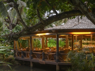 A luminous image of the Sandals Restaurant showcasing its tropical garden and palms surrounding the  area